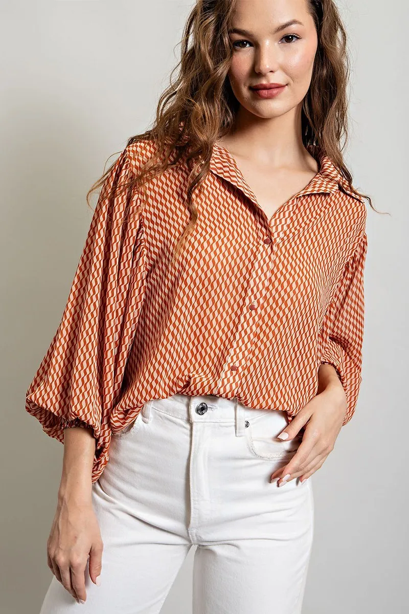 Printed blouse top with collared neckline, button down front, and smocked cuffs