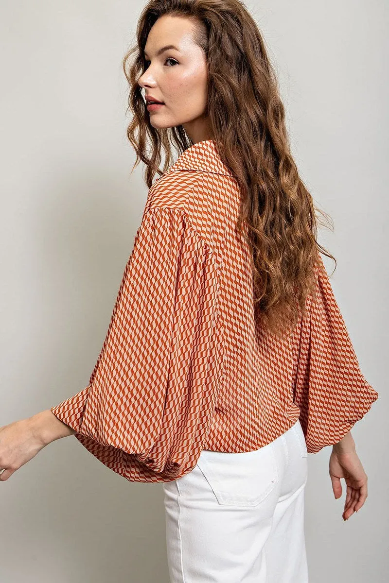 Printed blouse top with collared neckline, button down front, and smocked cuffs