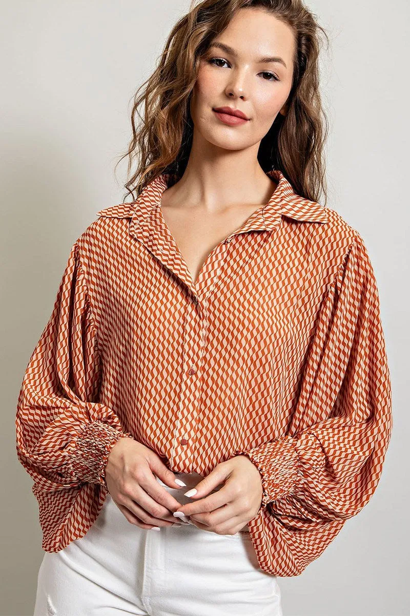 Printed blouse top with collared neckline, button down front, and smocked cuffs