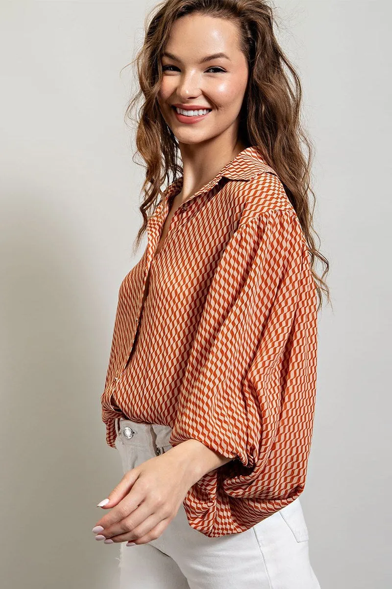 Printed blouse top with collared neckline, button down front, and smocked cuffs